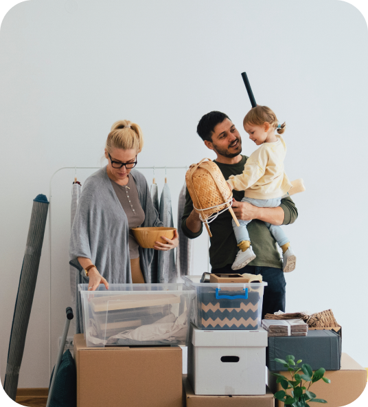 Young family with child moving boxes, illustrating Homage AI's property trade-in process.